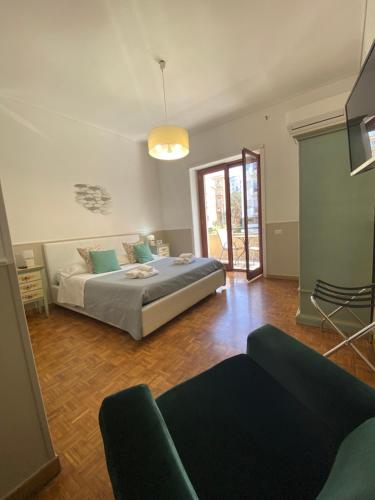 a bedroom with a bed and a couch in a room at Lemon Rooms Sorrento in Sorrento