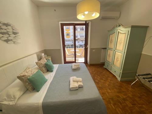 a bedroom with a large bed with towels on it at Lemon Rooms Sorrento in Sorrento
