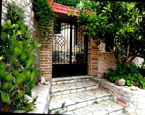 a entrance to a brick building with a black gate at Panorea's Stone House in Sidhirókastron