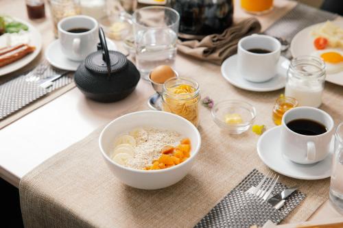 a table with a bowl of food and cups of coffee at Belvedere Luxury Apartments & Spa in Plakias