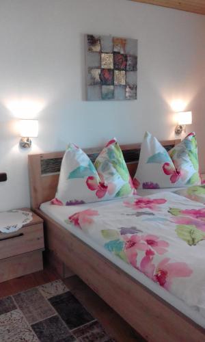a bedroom with a bed with flowers on it at Ferienwohnungen Fahringer Diana in Kössen
