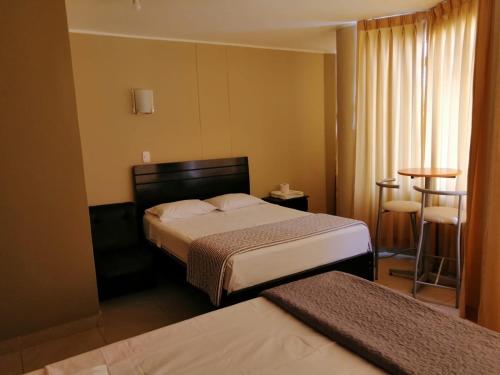 Кровать или кровати в номере HOSTAL LA NOCHE - Pisco