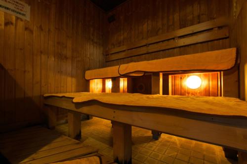 a room with two beds with a light in it at Highland Furano in Furano