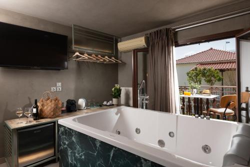 a large white bath tub in a kitchen at Tsikeli Boutique Hotel Meteora - Adults Friendly in Kalabaka