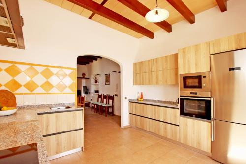 a kitchen with a refrigerator and a dining room at Villa Son Pons by Slow Villas in Llucmajor