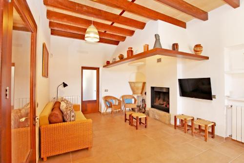 a living room with a couch and a fireplace at Villa Son Pons by Slow Villas in Llucmajor
