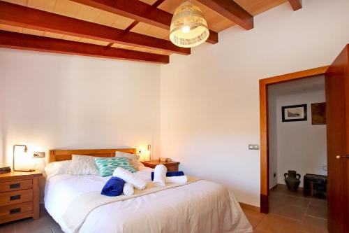 a bedroom with a bed with two towels on it at Villa Son Pons by Slow Villas in Llucmajor