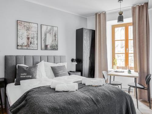 a bedroom with a bed with two pillows on it at Limehome Zwickau Hauptmarkt in Zwickau
