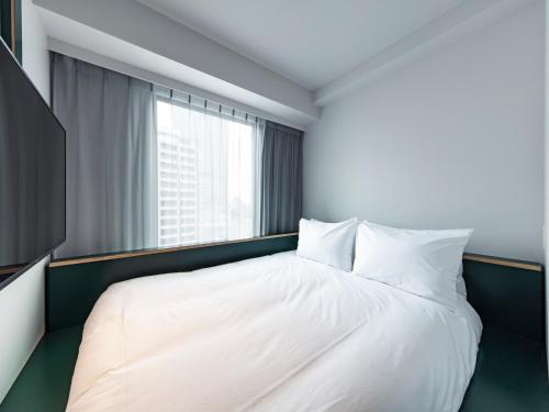Кровать или кровати в номере all day place shibuya
