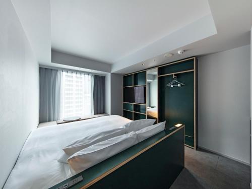 Кровать или кровати в номере all day place shibuya