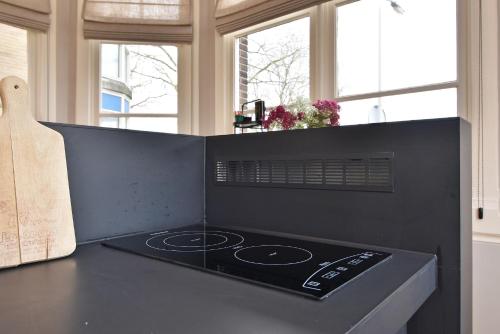 a stove top oven sitting on top of a kitchen counter at Boutique Hotel Havenkantoor in The Hague