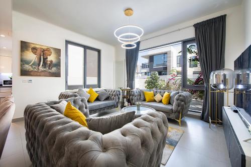 a living room with couches and yellow pillows at Modern Dubai Hills Luxury 4 BEDROOM VILLA in Dubai