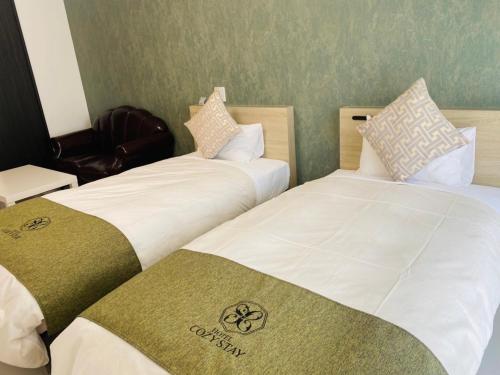 Postel nebo postele na pokoji v ubytování HOTEL Y'RISE TO URASOE