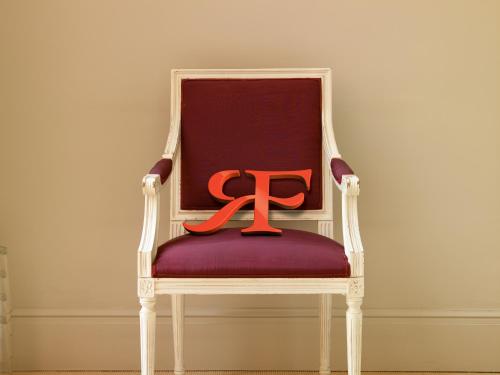 a red ribbon sitting on top of a chair at Rocco Forte Hotel De Russie in Rome