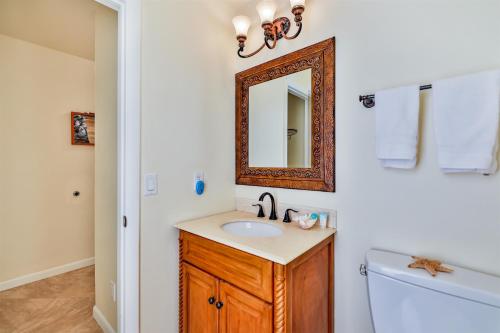 a bathroom with a sink and a mirror and a tub at Lake Palms 7 in Sanibel