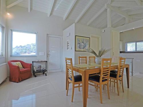 a dining room with a table and chairs at Sunray studio in Poros in Poros