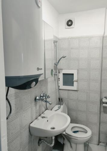 a bathroom with a toilet and a sink at Sunrise Apartment in Burgas