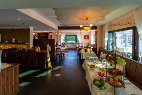 a restaurant with tables with food on them at Hotel Nordstern in Neuharlingersiel