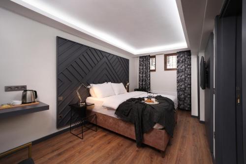 a bedroom with a bed with a large wall at Xenia Hotel Istanbul in Istanbul