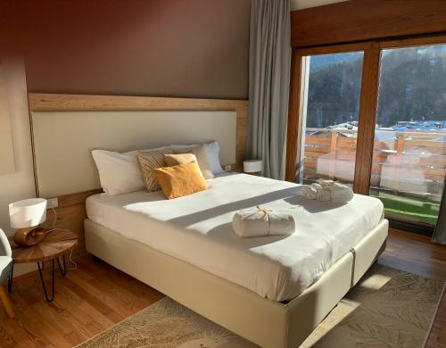 a bedroom with a large bed with two bags on it at Appartamento Carducci in Pieve di Cadore