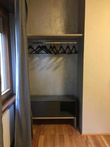 a empty wine rack in a room with a window at Appartamento Carducci in Pieve di Cadore