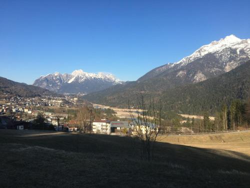 a view of a valley with snow capped mountains at Appartamento Carducci in Pieve di Cadore