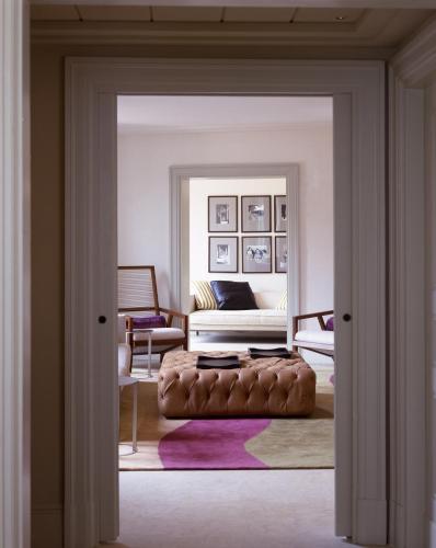 a living room with a couch and a bed at Rocco Forte Hotel De Russie in Rome