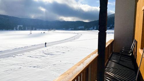 a view of a snow covered field from a porch at Appartements Wolf in Leutasch