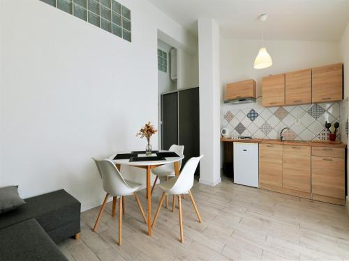 a kitchen and dining room with a table and chairs at Apartments Helena in Murter