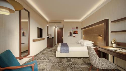a hotel room with a bed and a desk at Ramada Jerusalem Hotel in Jerusalem