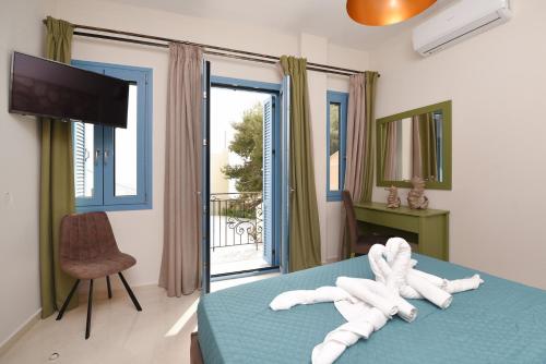 a bedroom with a bed with white towels on it at Syrene Luxury Suites in Ermoupoli