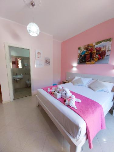 a bedroom with a bed with stuffed animals on it at Le Twins -Bed and Breakfast in Tropea
