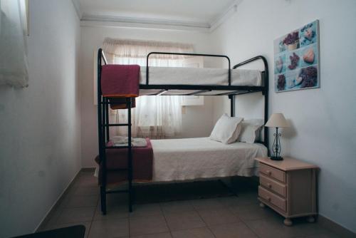a bedroom with a bunk bed and a dresser at Guesthouse da Vila in Mourão