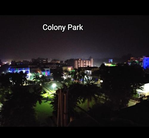 a view of a city at night with lights at Max Guest House in Agra