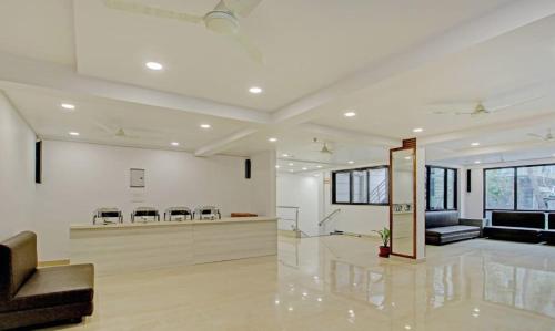 a large living room with white walls and a lobby at PARKSTONE in Kolkata
