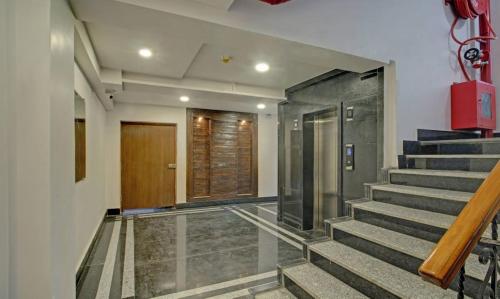 a hallway with stairs with a door and a door at PARKSTONE in Kolkata