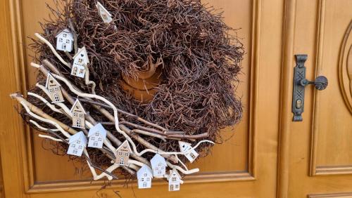 a wreath on a door with house tags on it at Pension Rondel in Poděbrady