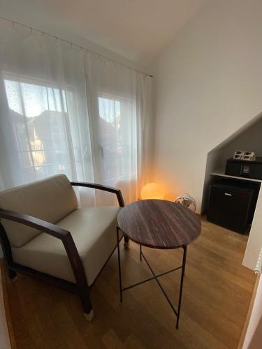 a living room with a couch and a table at Hotel Lestelle - self check-in in Luzern