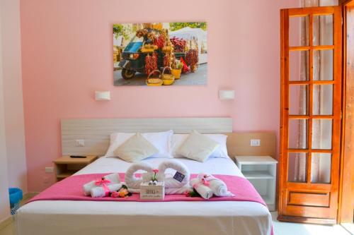a bedroom with a bed with stuffed animals on it at Le Twins -Bed and Breakfast in Tropea