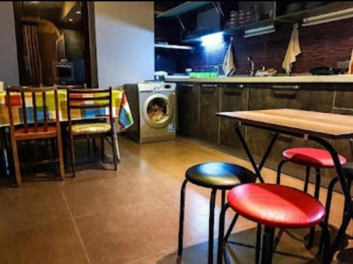a kitchen with a table and chairs and a stove at Museum Hostel in Tbilisi City