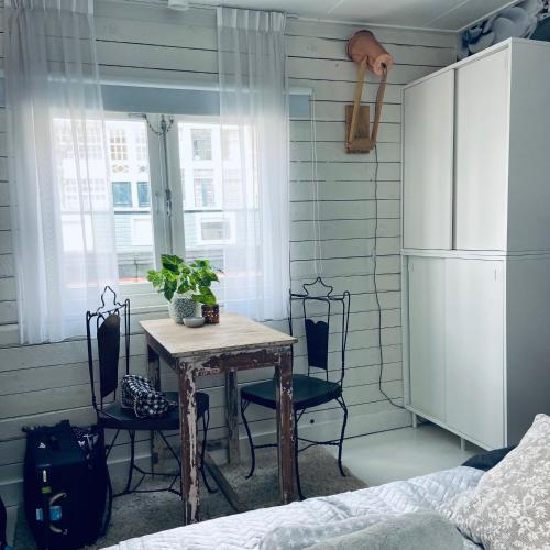 a room with a table and chairs and a refrigerator at Houseboat Bonnie in Amsterdam