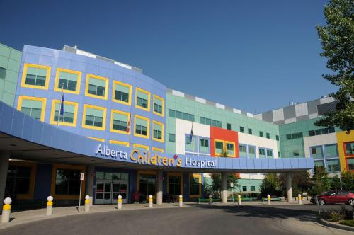 a building with a car parked in front of it at Best Western Plus Village Park Inn in Calgary