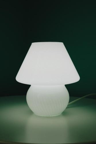 a white lamp with a white shade on a table at Locanda La Castellana in Castello d'Agogna
