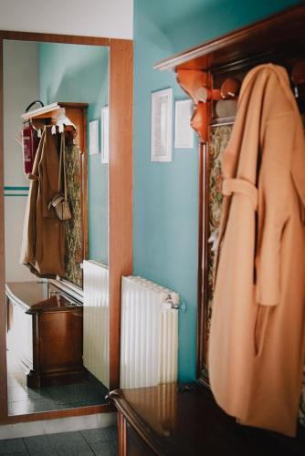 a bathroom with a towel hanging on a closet at Locanda La Castellana in Castello d'Agogna
