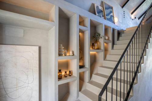 a staircase in a home with white walls and white stair shelves at Victoria XV in Cascais