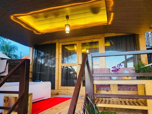 a porch of a house with a yellow ceiling at Agonda Serenity Beach Villa in Agonda