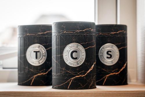 three black energy drink cans sitting on a shelf at Slow Down Texel in Den Burg