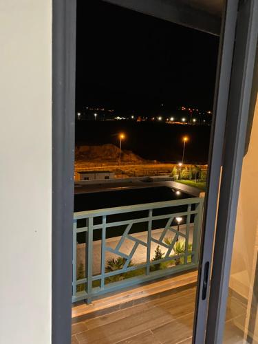 a view from a window of a balcony at night at Oceanica by Smir Park luxury apartment Marina Smir in M'diq