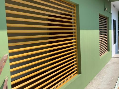 a wooden slat wall on the side of a building at Airavatham Apartments in Guruvāyūr