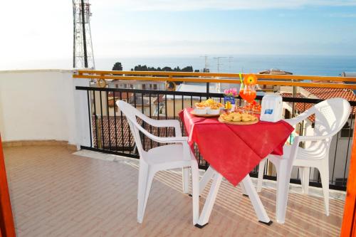 a table with a plate of food on a balcony at Le Twins -Bed and Breakfast in Tropea